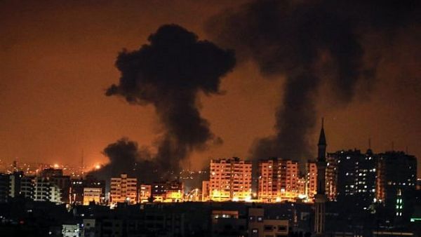 A picture taken on August 8, 2018 in Gaza City shows smoke plumes rising following an Israeli air strike (AFP/ MAHMUD HAMS)