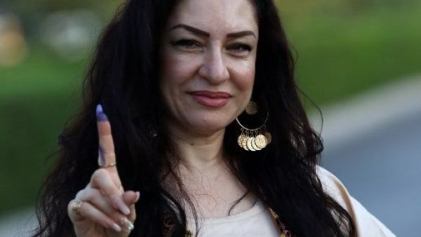 An Iraqi Kurdish woman shows her ink-stained index finger after casting her ballot for the parliamentary election at a polling station in Arbil, the capital of the Kurdish autonomous region in northern Iraq, on September 30, 2018. 
SAFIN HAMED / AFP