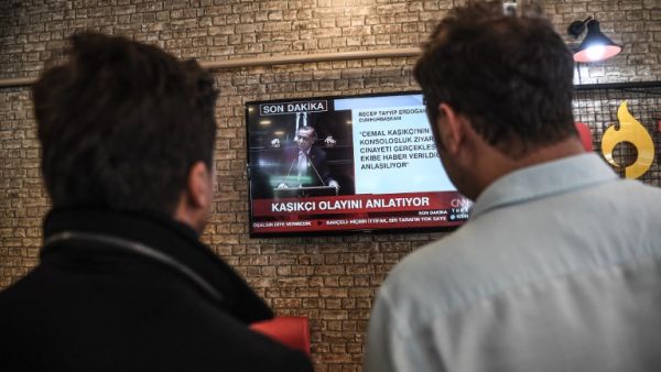People watch on a TV the speech of Turkish president Recep Tayyip Erdogan (AFP)