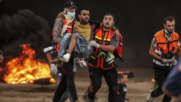 Palestinian paramedics carry away a protester who was injured during clashes following a demonstration near the border with Israel east of Gaza City on October 26, 2018. (MAHMUD HAMS / AFP)