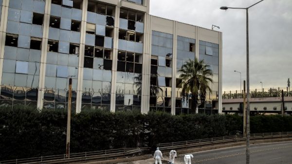 Greek police experts search for evidence after a bomb blast outside the Greece's SKAI TV building in Athens on December 17, 2018. (AFP)