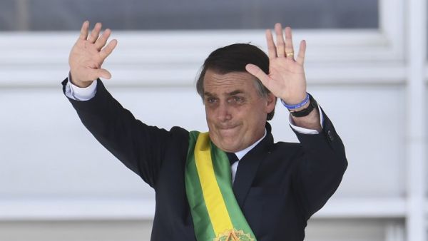 Brazil's new President Jair Bolsonaro waves to the crowd after receiving the presidential sash during his inauguration ceremony, at Planalto Palace in Brasilia on January 1, 2019. (AFP/File)