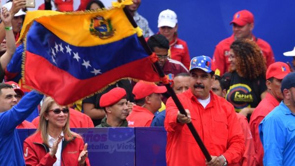 Venezuelan President Nicolas Maduro waves a national flag during a gathering with supporters to mark the 20th anniversary of the rise of power of the late Hugo Chavez. (AFP/ File)