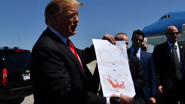 US President Donald Trump show a map which he said indicates the end of ISIS, as he arrives at Palm Beach International Airport in Florida on March 22, 2019. (Nicholas Kamm / AFP)
