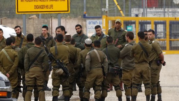 Israeli soldiers stand guard at the Quneitra border crossing of the Israeli annexed-Golan Heights, on March 23, 2019. (AFP/ File Photo)