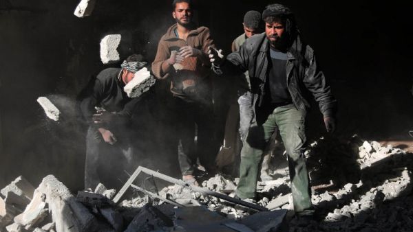 Syrians search for victims amidst the rubble of a destroyed building following airstrikes that hit a kindergarten in the rebel-held region of Eastern Ghouta, near Damascus on January 12, 2016. (AFP/Amer al-Mohibany)