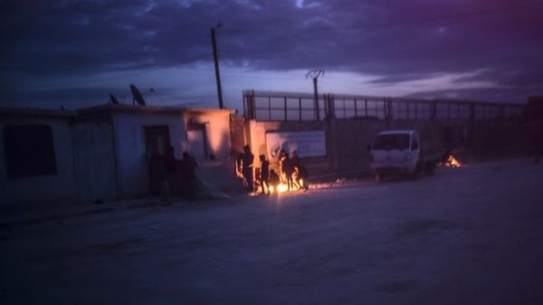 Syrians fleeing the northern embattled city of Aleppo wait on February 5, 2016 in Bab-Al Salama, next to the city of Azaz, northern Syria, near Turkish crossing gate. (AFP/Bulent Kilic)