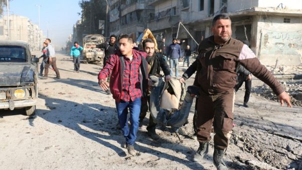 Syrians carry the body of a victim following a reported Syrian regime air strike in a rebel-controlled area in the northern city of Aleppo, on February 8, 2016. (AFP/Ameer al-Halbi)