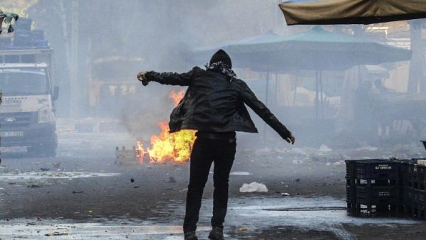 A protester stands close to a fire, during clashes between Turkish forces and Kurdish people in the center of Diyarbakir, during a protest against a curfew in the Sur district of Diyarbakir, on March 2, 2016. (AFP/Ilyas Askengin) A protester stands close to a fire, during clashes between Turkish forces and Kurdish people in the center of Diyarbakir, during a protest against a curfew in the Sur district of Diyarbakir, on March 2, 2016. (AFP/Ilyas Askengin)