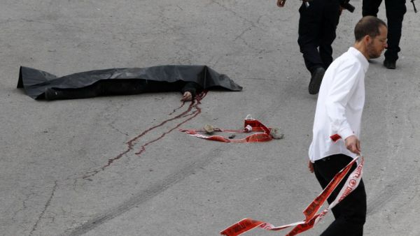 The body of a Palestinian assailant who was allegedly shot in the head by an Israeli soldier as he lay wounded on the ground Hebron on March 24, 2016. (AFP/Hazem Bader)