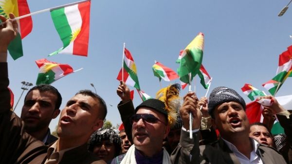 Iraqi Kurdish protesters wave flags of their autonomous Kurdistan region during a demonstration (AFP File Photo)