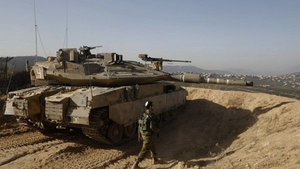 Israeli soldier walking next to a tank. (AFP/ File)