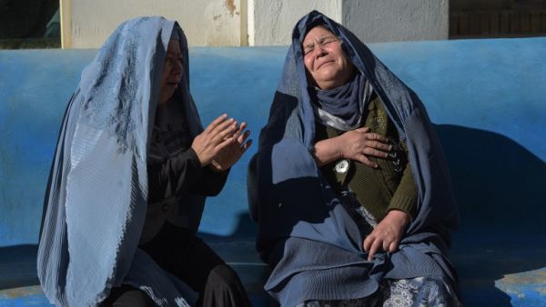 Two Afghan women weep for their relatives at a hospital following explosions at a Shiite cultural centre in Kabul on Dec. 28, 2017. (AFP/ SHAH MARAI)