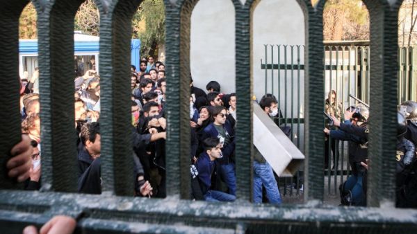 Iranian students scuffle with police at the University of Tehran during a demonstration driven by anger over economic problems, in the capital Tehran on Dec. 30, 2017 (STR/AFP)