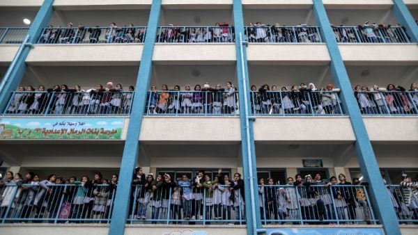 Palestinian schoolgirls pose for a group picture outside their classrooms at a school belonging to the United Nations Relief and Works Agency for Palestine Refugees (UNRWA) in Gaza City on Jan. 22, 2018 (MAHMUD HAMS / AFP)