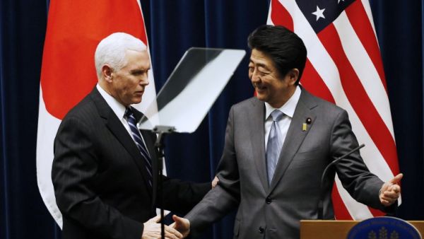 U.S. Vice President Mike Pence (L) and Japan's Prime Minister Shinzo Abe shake hands during their joint announcement after their meeting at Abe's official residence in Tokyo on Feb. 7, 2018 (TORU HANAI / POOL / AFP)