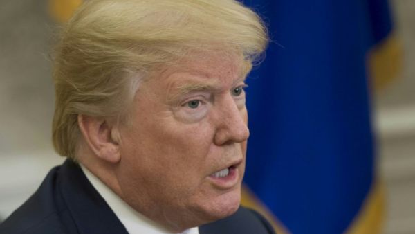 US President Donald Trump speaks to the press in the Oval Office of the White House in Washington, DC, Feb. 9, 2018. 
(SAUL LOEB / AFP)
