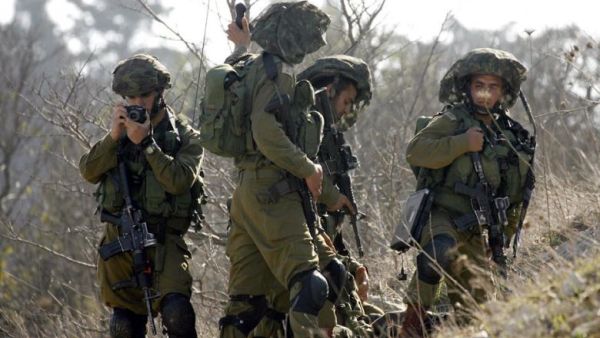  Israeli soldiers patrolling along the Israeli border (AFP/File Photo)