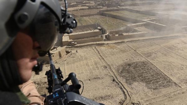 An Afghan soldier looks out from a helicopter over part of Paktika province. (AFP/Shah Marai)
