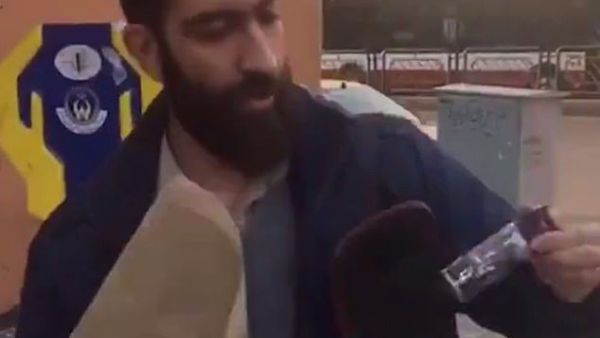 The woman filmed herself arguing with the man about the country's strict regime before he pulled a black bottle from his bag (right) and sprayed it in her face (Twitter)