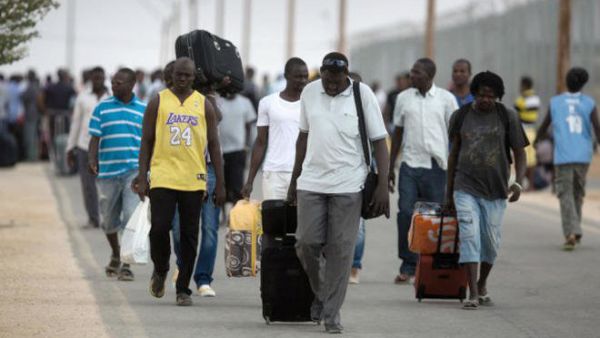 African migrants carry their belongings at a detention center in Israel's Negev desert (AFP/File Photo)