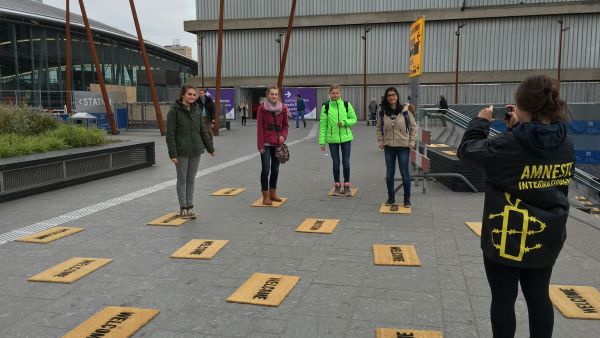 Students lay down "welcome" door mats for Syrian refugees in Netherlands as part of the Utrecht Welcomes Refugees project for Amnesty International. 