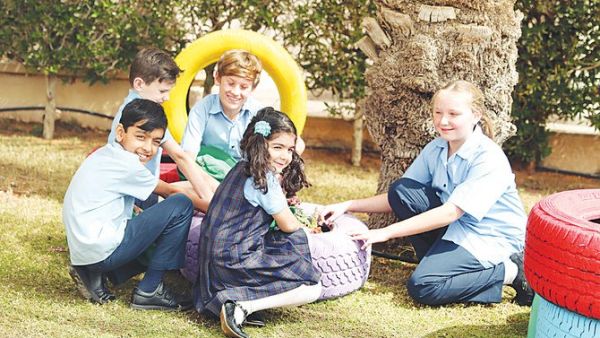 Students at the British International School Riyadh using tires for planting. (AN photo by Bashir Saleh)