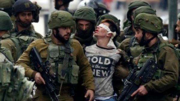 Israeli Occupation Forces arrest a Young Palestinian Man (AFP/File Photo) Israeli Occupation Forces arrest a Young Palestinian Man (AFP/File Photo)