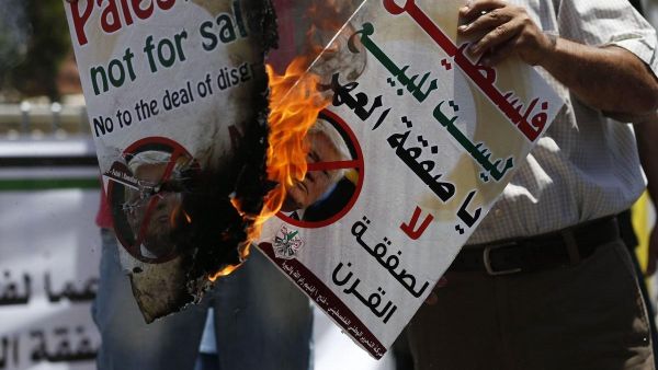 Palestinians protest against Trump's deal of the century in the West Bank city of Ramallah on 2 July 2018 [Abbas Momani/AFP/Getty Images]