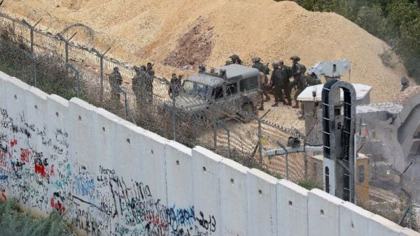 Israeli soldiers gathering near an Israeli excavation site for reported cross-border Hezbollah-dug tunnels (AFP /Mahmoud ZAYYAT)