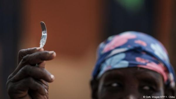 A woman with a rough blade used for FGM in Uganda. (AFP/ File)