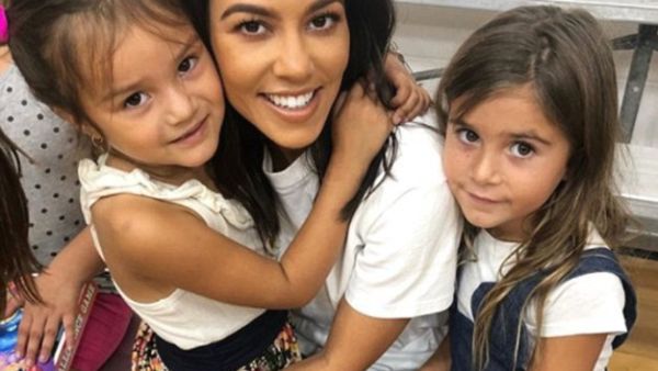 Kourtney Kardashian (middle), 39, brought her daughter Penelope, six (right), to the Watts Empowerment Center this Wednesday, where the little girl 'made a new friend' (left) (Instagram)