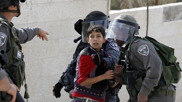 Israeli soldiers detain a Palestinian boy during a protest in the Aida refugee camp, near Bethlehem in the West Bank. (AFP/File)