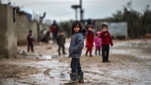 Children stand in a muddy street at a refugee camp on Jan. 26, 2018 at the Syrian town of Azaz (AFP)