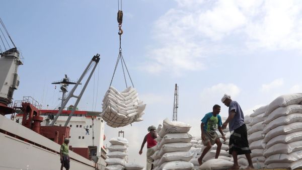 Workers unload food aid provided by Unicef from a cargo ship in war-torn Yemen's main port of Hodeida in January. (AFP/ File)