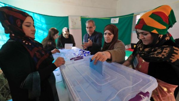 A Syrian woman casts her vote in local elections held in the Kurdish-dominated northern city of Qamishli (AFP/Delil souleiman)