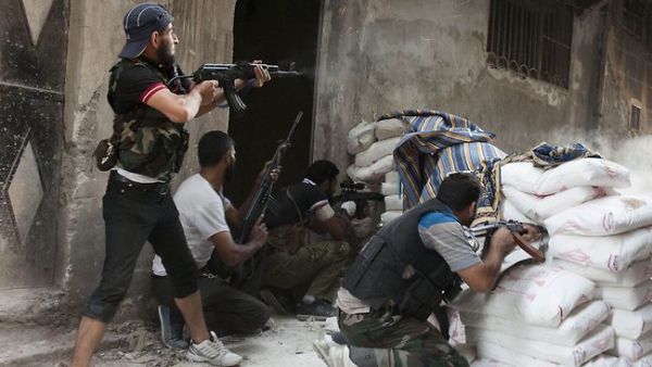 Fighters of the Free Syrian Army exchange fire with regime forces in Aleppo. (AFP/File)