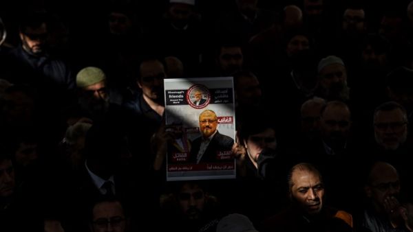 A person holds a banner of Jamal Khashoggi during a symbolic funeral prayer for the Saudi journalist (AFP)
