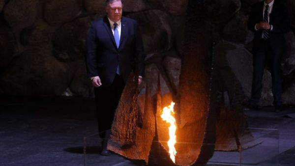 US Secretary of State Mike Pompeo stands next to the eternal flame at a ceremony commemorating the six million Jews killed by the Nazis during the Holocaus (AFP)