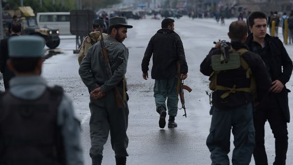 Afghan security forces at the site of a car bombing earlier on April 19. (AFP/Shah Marai) Afghan security forces at the site of a car bombing earlier on April 19. (AFP/Shah Marai)