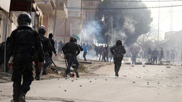 Anger grew over the death of a journalist who set himself on fire over economic conditions, prompting clashes to spread from an impoverished western city overnight. (AFP)