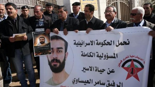 Palestinian protesters hold placards during a demonstration in Ramallah in support with Palestinian prisoners held in Israeli jails, some of whom are observing a hunger strike. (AFP PHOTO/ABBAS MOMANI)