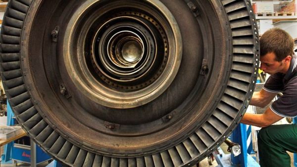 A trainee dismantles a gas turbine for maintenance work in a factory in Ludwigsfelde, Germany. President Trump has called the German apprenticeship system a model program.  (© AP Images)