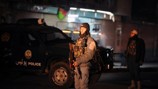 This picture taken on January 10, 2017 shows Afghan policemen standing guard at the site of an explosion near the governor's compound in Kandahar. (AFP/Jawed Tanveer)
