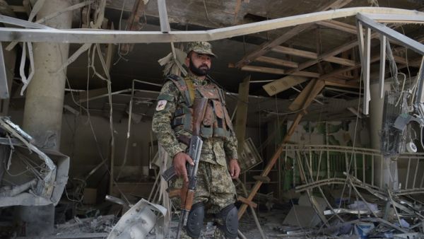 A Afghan security personnel keeps watch at the site of a suicide attack outside a bank near the US embassy in Kabul on August 29, 2017 (AFP)