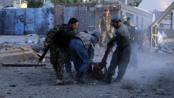 Security forces lift dead body of colleague after Taliban attack on US consulate. [AFP]