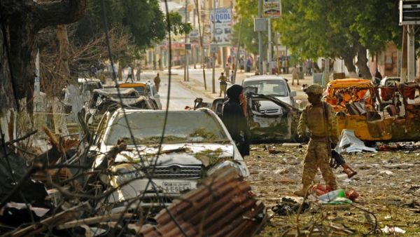 A Somali soldier responds to the Ambassador Hotel bombing in Mogadishu, Somalia. (AFP/Mohamed Abdiwahab)