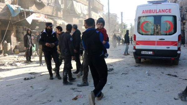 Aleppo residents walk toward an ambulance after one of many Russian airstrikes on the town. (AFP/File)