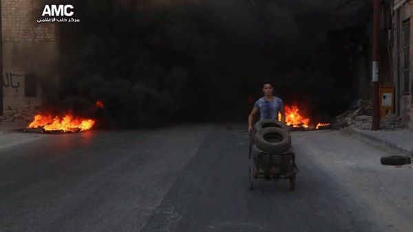 Syrian kids burning tires in Aleppo to confuse warplanes (Twitter/@ShamiRebel/Aleppo Media Center)