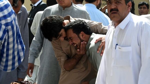 Pakistani journalists grieve over the body of a news cameraman after an explosion at a government hospital in Quetta on Monday. (AFP/File) 